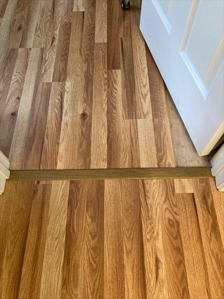 For this flooring installation project in Haverhill, MA, we put down laminated flooring on the second-floor hallway and put in three transition pieces that lead into the bedrooms and bathroom. We also put one on top of the step.
