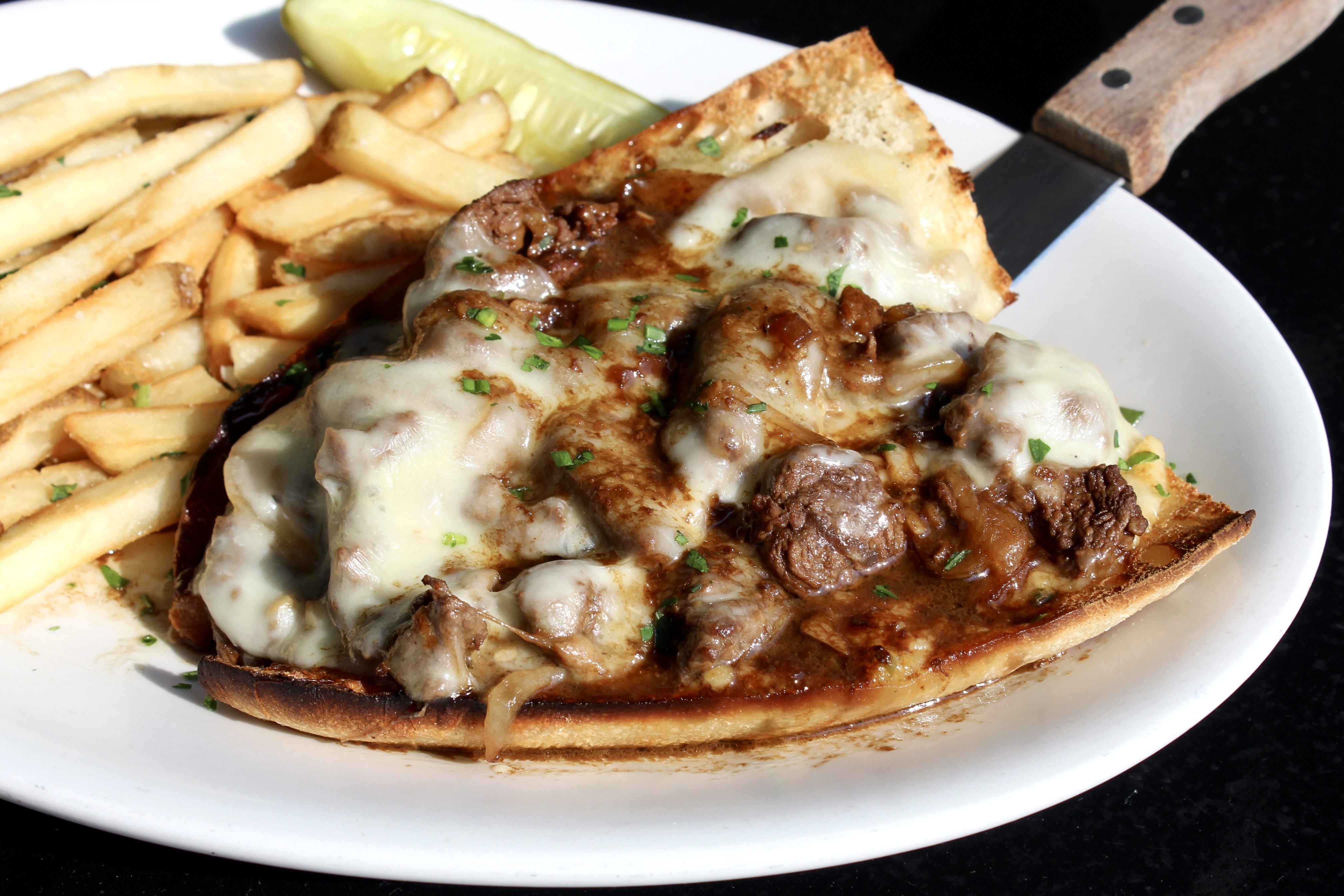 Tenderloin Sandwich served open-face with fried onions and melted provolone 