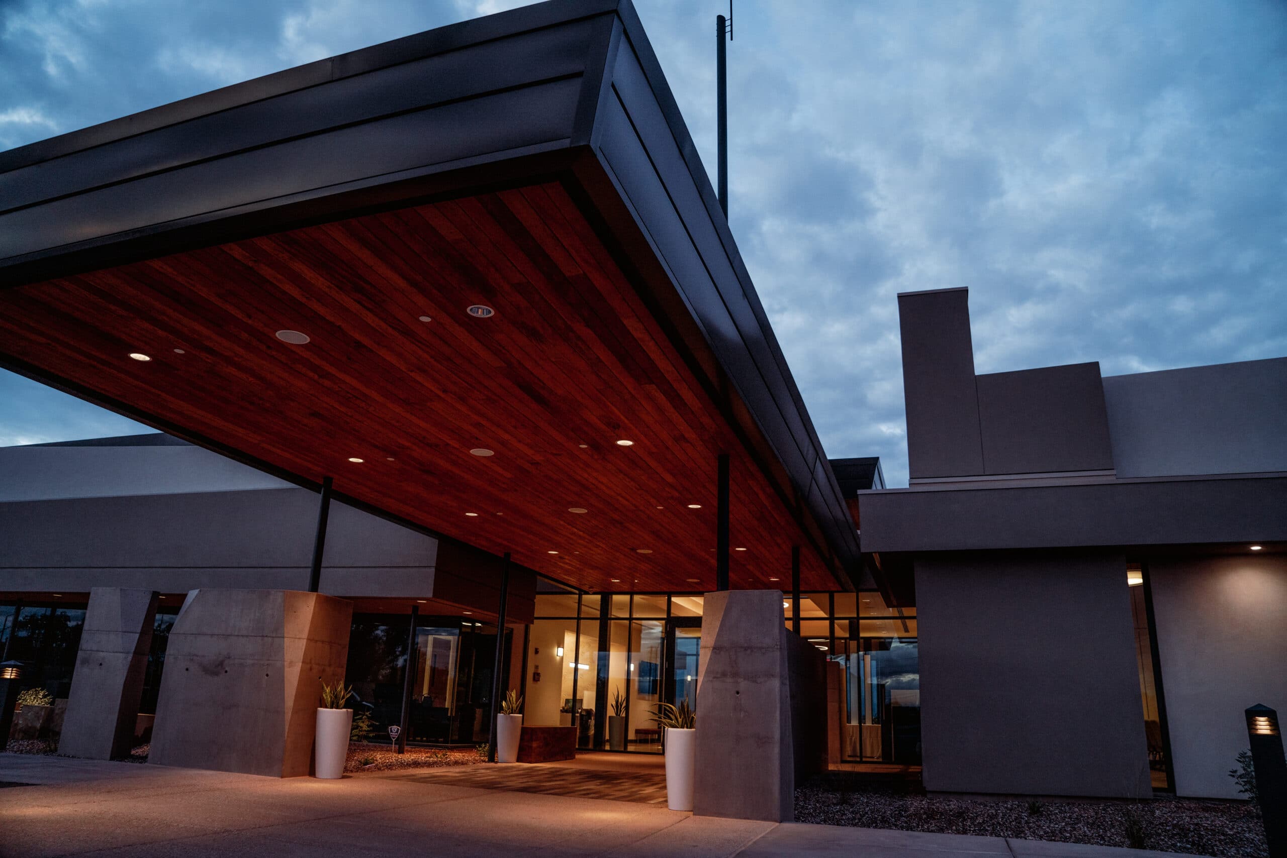 The wood-lined canopy over the main entrance at Gilbert Memorial Park, lit in the evening.