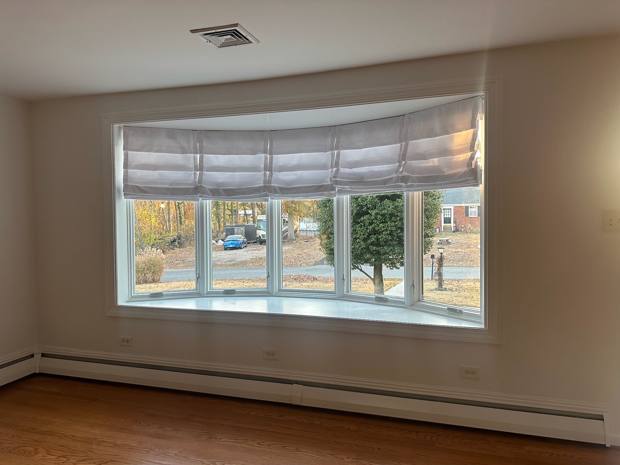 Hobbled roman shades are a unique way to showcase your bow window.