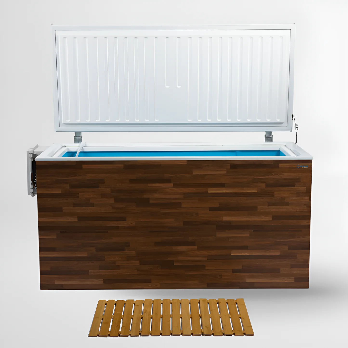 An open chest freezer with a wooden exterior and a blue interior lining is shown against a white background. A wooden slatted mat lies on the floor in front of the freezer. The lid of the freezer is propped open, revealing the ribbed interior of the lid and the bright blue liner of the freezer compartment.