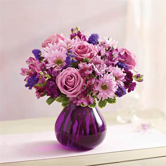 Lavender Dreams™ - Send her this truly original bouquet of lovely roses, daisy poms, stock, alstroemeria and monte casino in shades of pink and purple.
