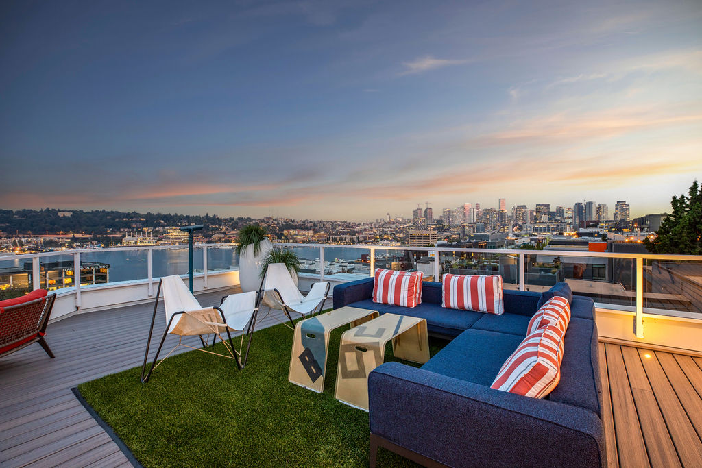 A patio with a view of the city at dusk.