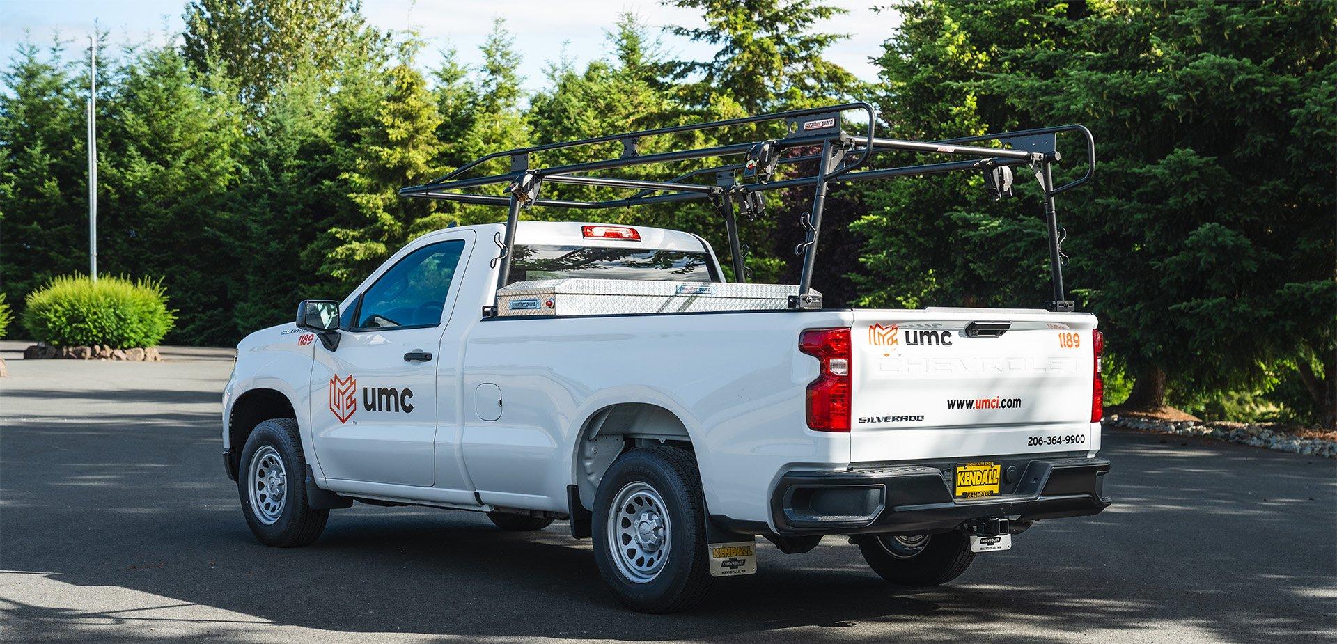 Work truck upfit with a ladder rack, crossover toolbox and UMC fleet lettering, all completed by Ardor Printing.