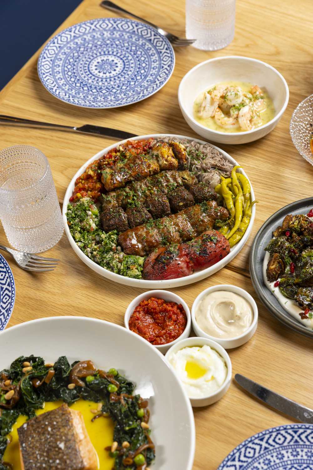 Our delicious kebab platter comes with lamb, kofte, chicken, and adana kebabs served with tomato, on 
