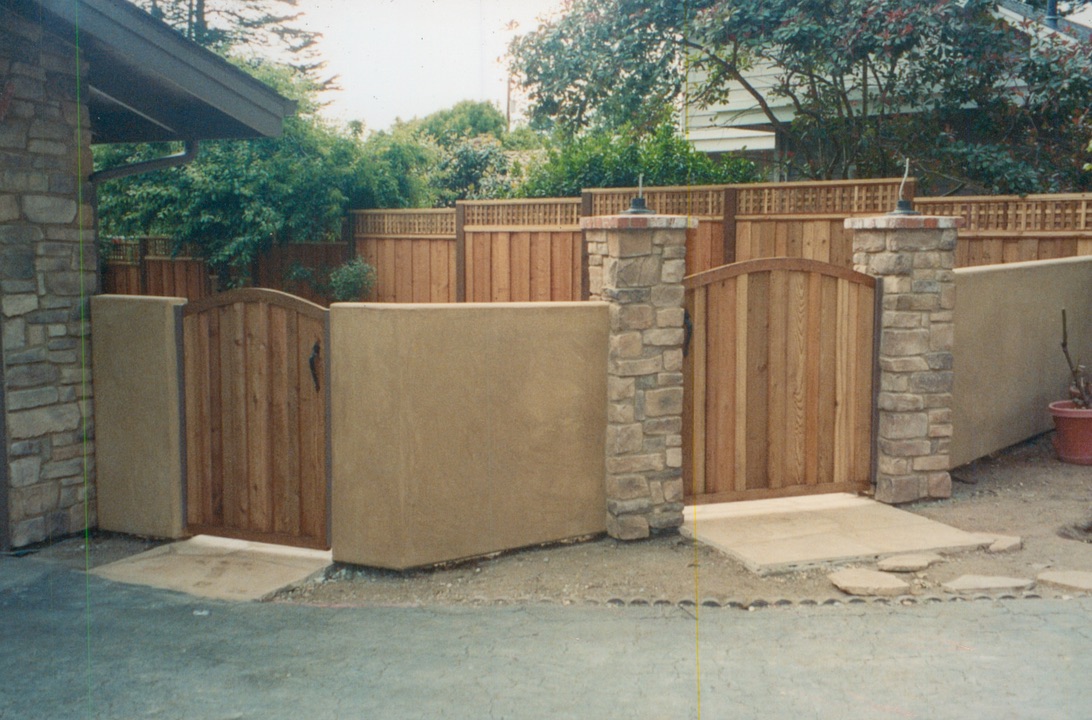 Custom wood gate and fence installation providing secure access and a finished look for the property.