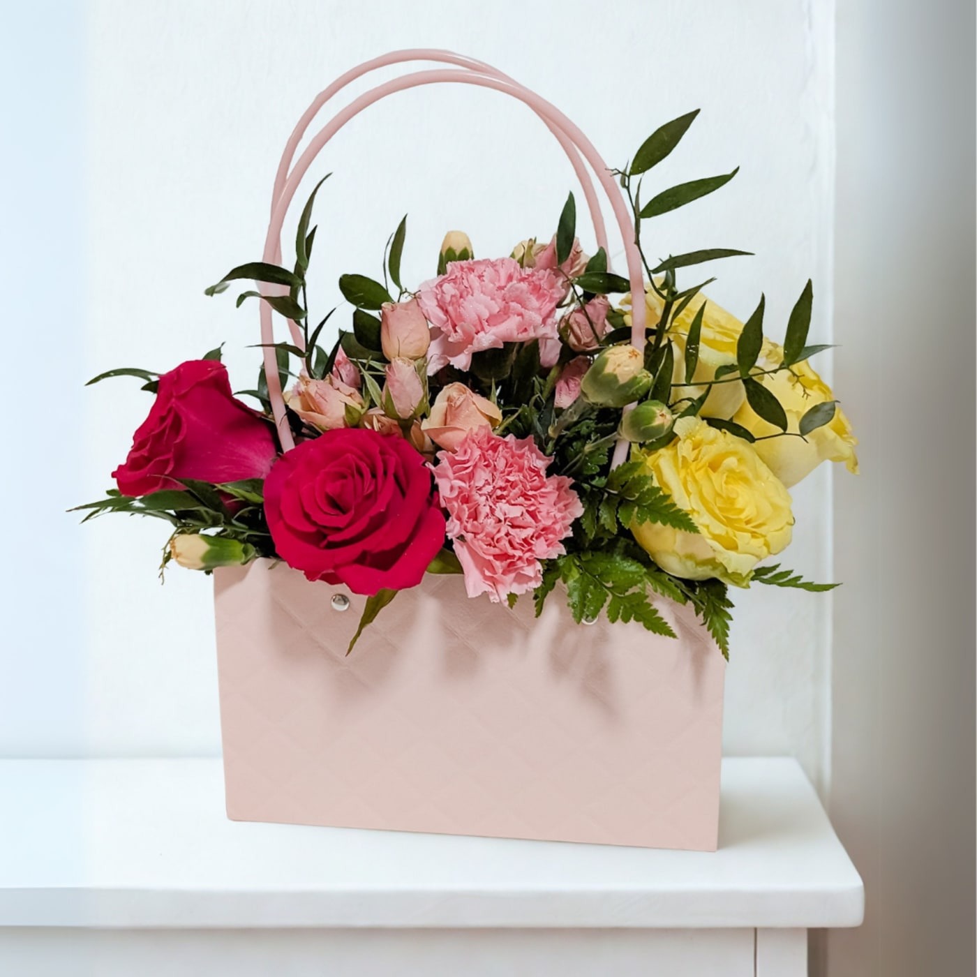 Each Designer's Choice Floral Bag is uniquely handcrafted using the freshest premium seasonal blooms available. Our designers thoughtfully select each flower to create a balanced, luxurious arrangement full of texture, color, and beauty. Because we work with seasonal flowers, no two designs are exactly alike, making every arrangement one of a kind.