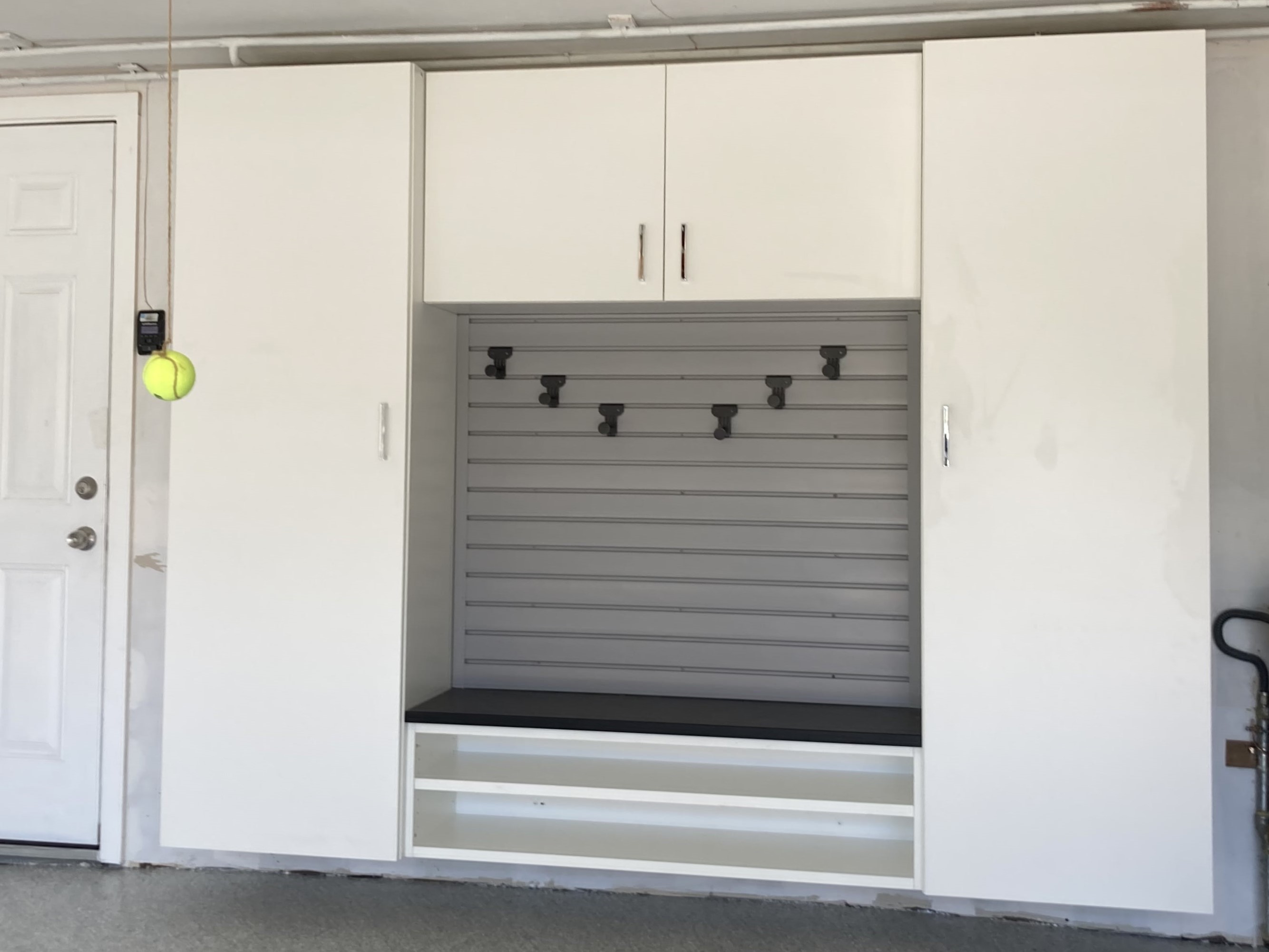 Custom bench with cabinets by Premier Garage