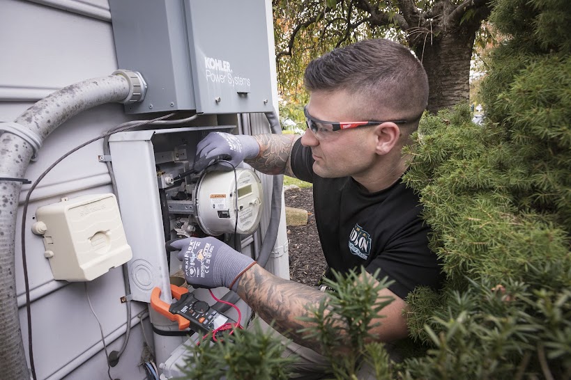 Thomas Edison Electric technician inspecting and testing electrical meter and power connections as part of residential service in Pennsylvania