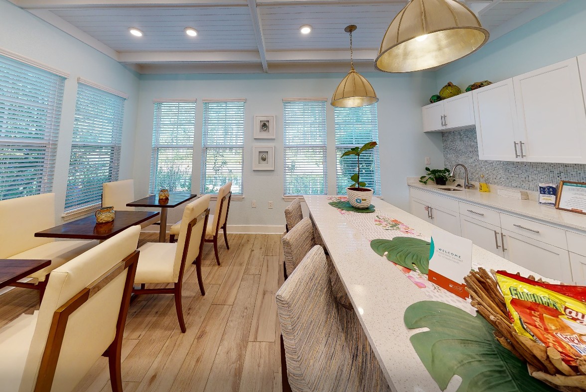 A bright community kitchen and dining space with modern finishes and casual seating.