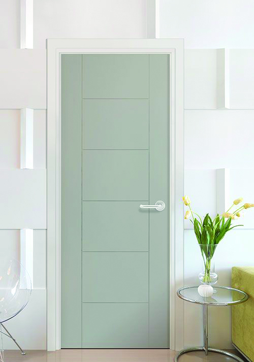 Modern interior door with a smooth light-gray finish and horizontal panel design, set against a contemporary white geometric wall with a glass side table and vase of flowers nearby.