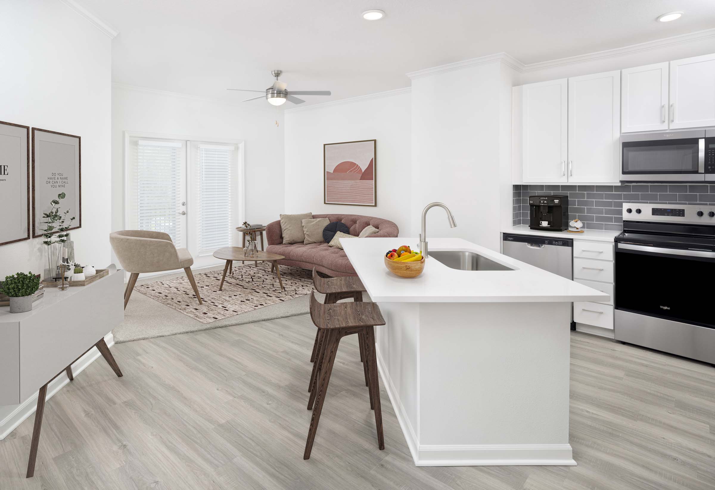 Open-concept living room and kitchen at Camden Montague apartments in Tampa, FL