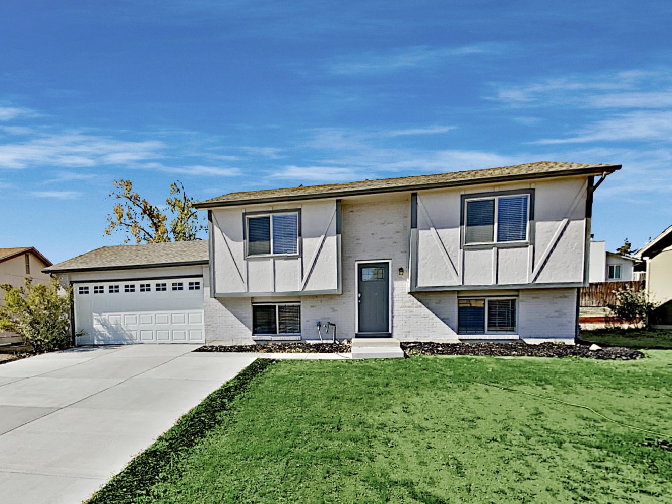 Beautiful front of home with two-car garage at Invitation Homes Denver.