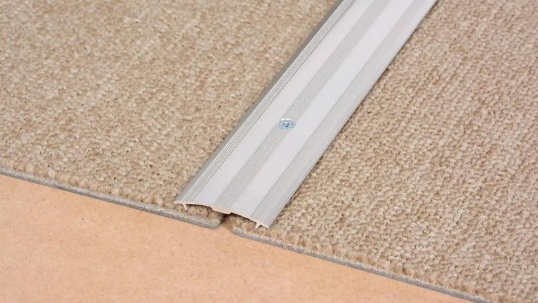 A Silver flooring bar connecting two carpets