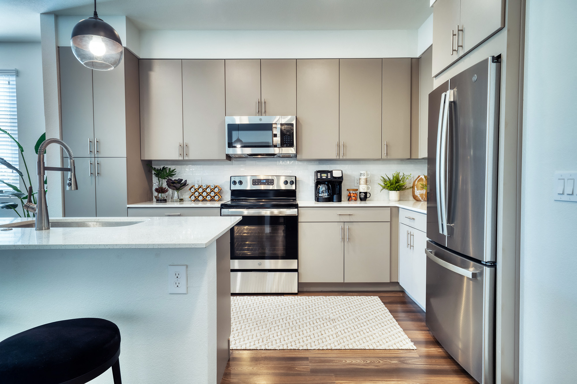 a kitchen with stainless steel appliances and white cabinets