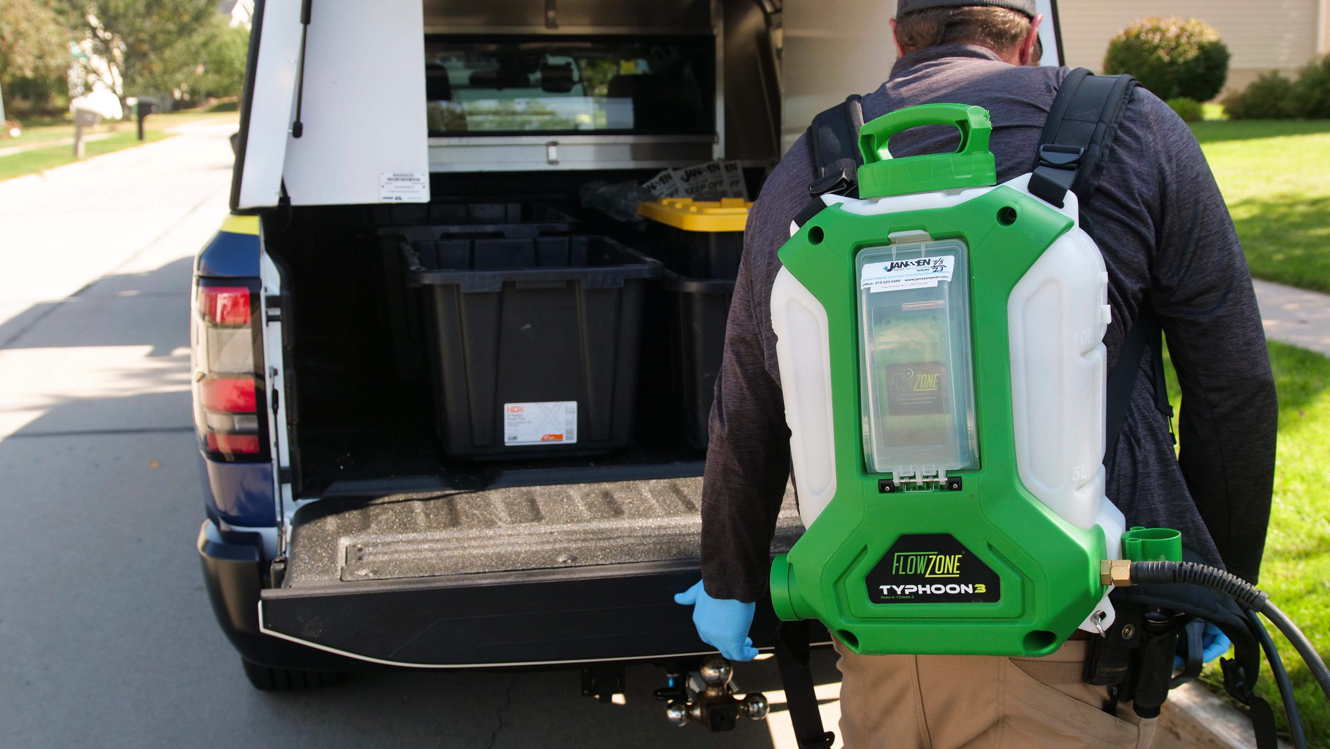 Janssen Pest Solutions technician wearing a bug treatment straying machine.