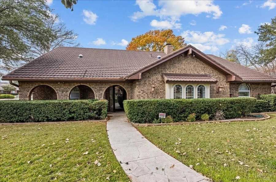 A completed stone-coated metal roofing system enhances curb appeal while providing exceptional durability, weather resistance, and long-term protection for a well-maintained residential property with landscaped surroundings.