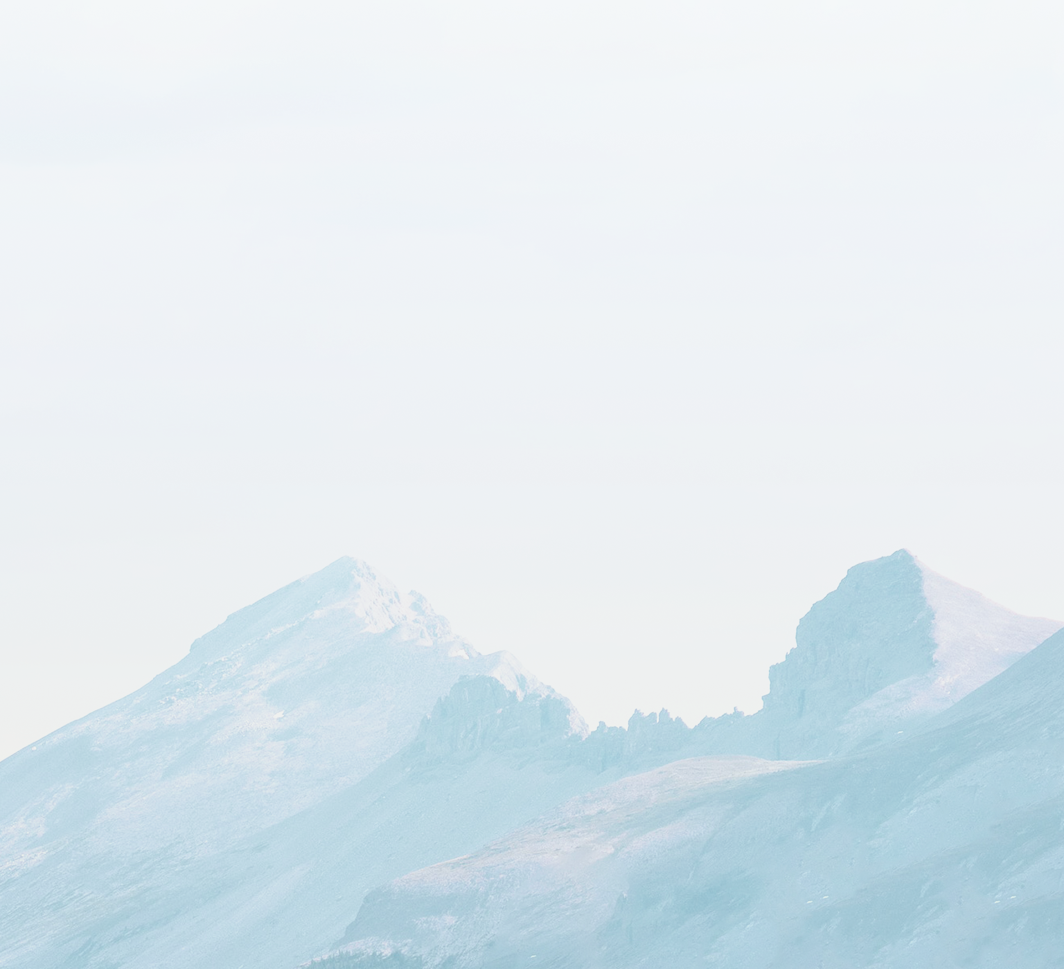 Rugged, snow-capped mountain peaks.