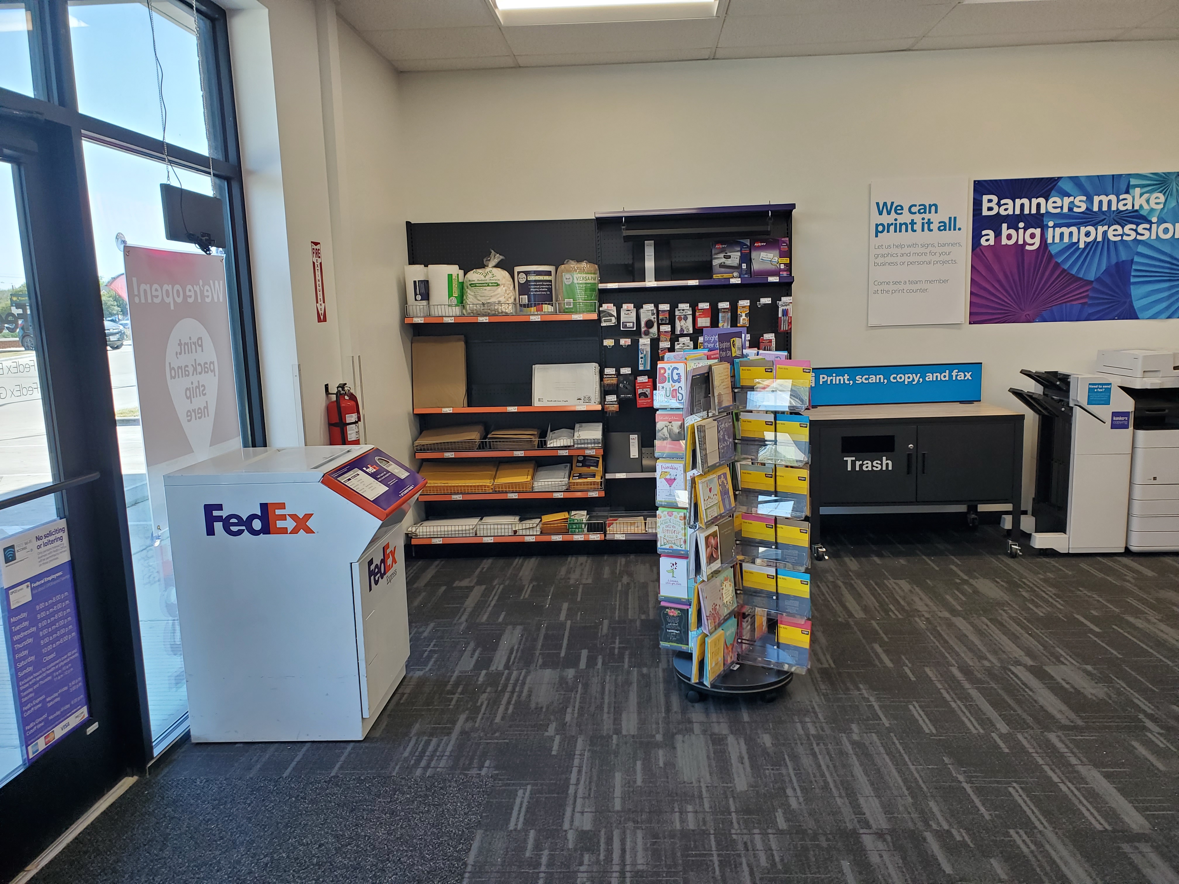 Retail area inside FedEx Office College Station Texas with shipping supplies, packaging materials, and customer self-service printing station.