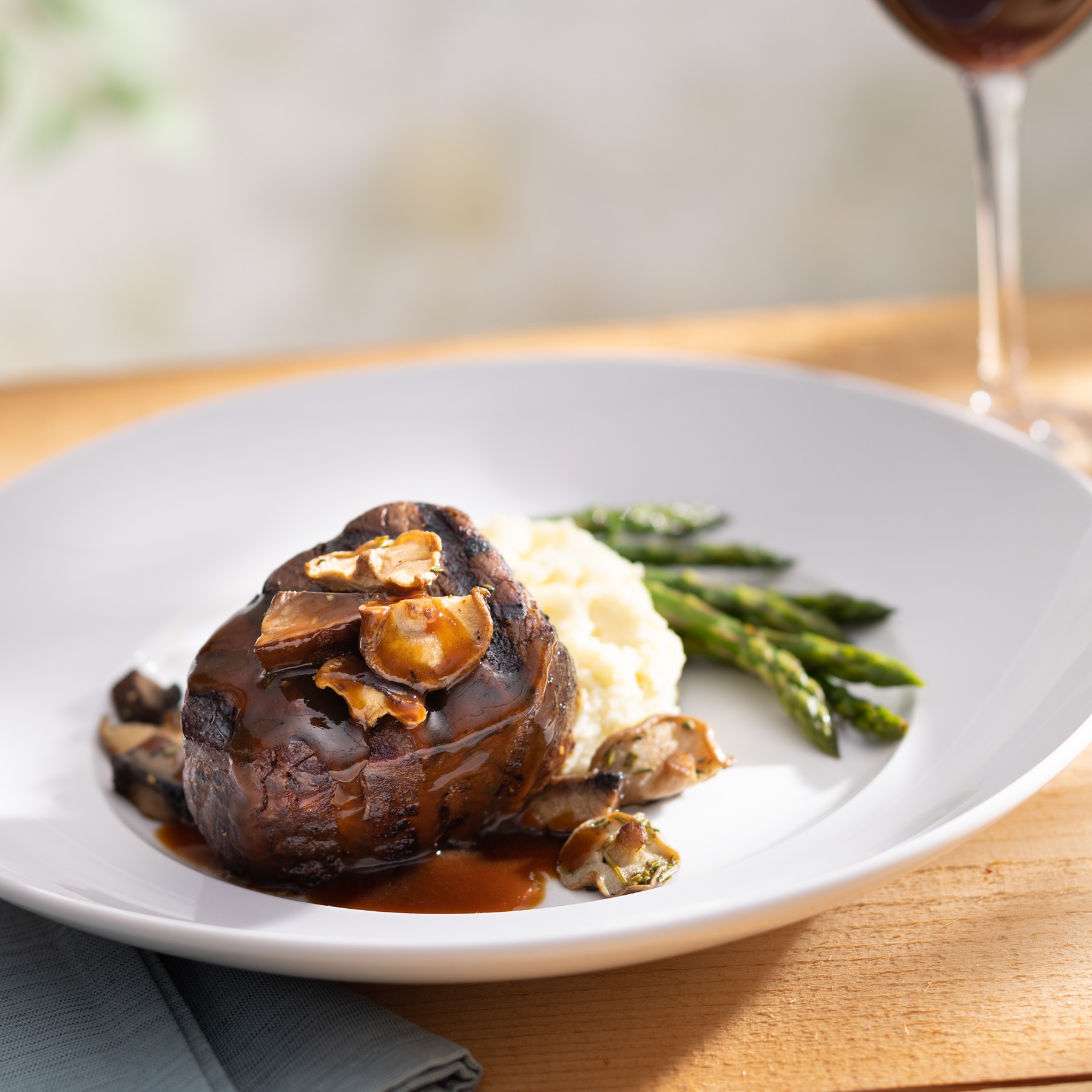 Wood-Grilled Filet Mignon served with asparagus, Yukon mash, red wine and mushroom sauce.