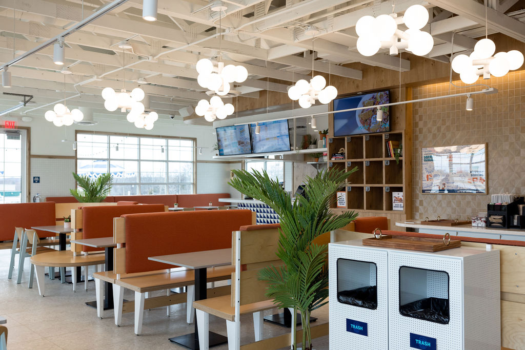 Interior of Birdcall McKinney, showing off the dining room booths and wall of food pick up bays.