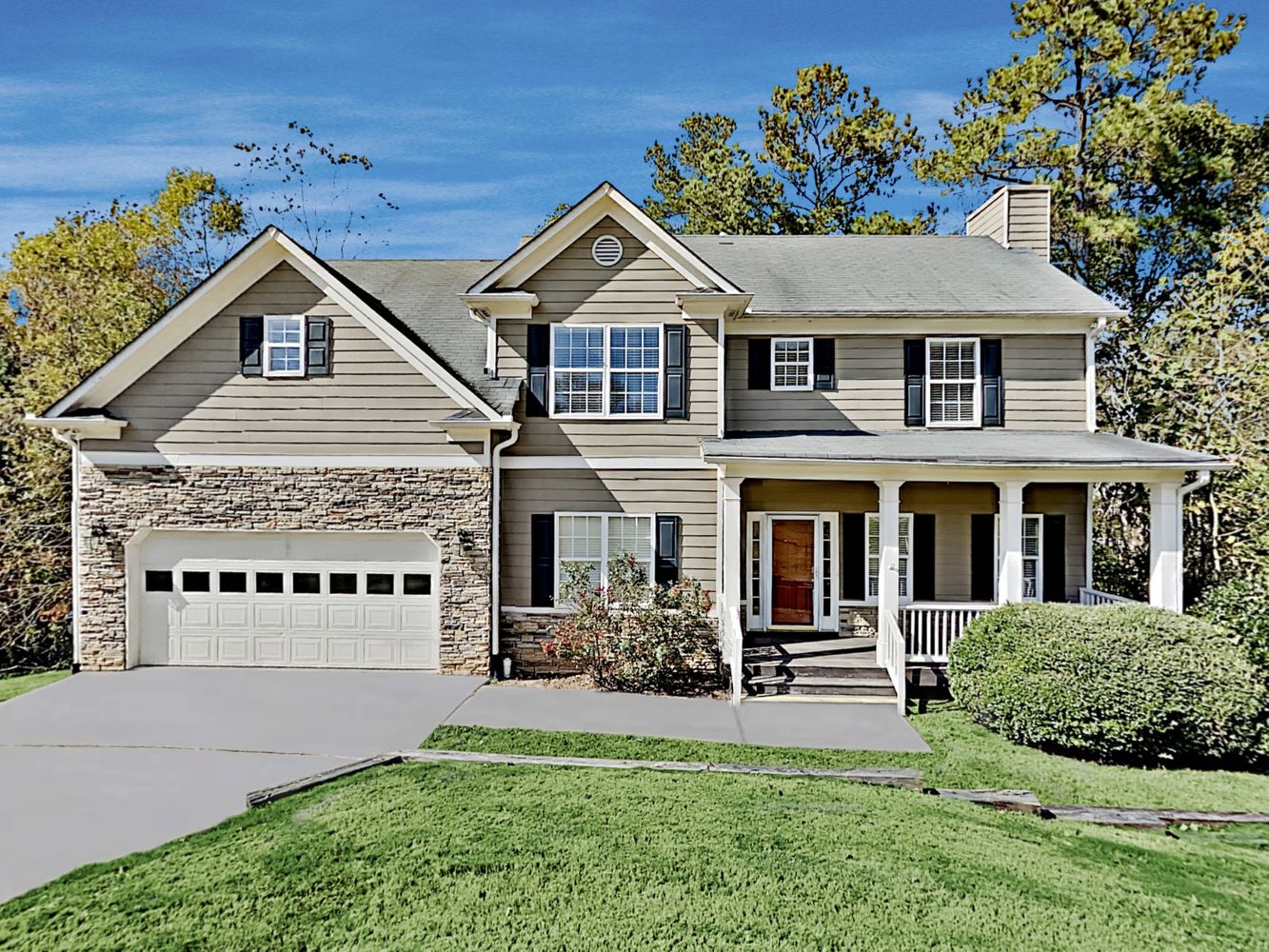 Stunning home with a two-car garage and covered patio at Invitation Homes Atlanta.