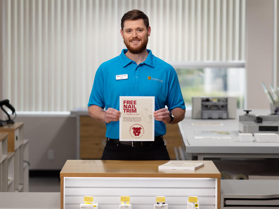 Associate printing flyers at the UPS Store