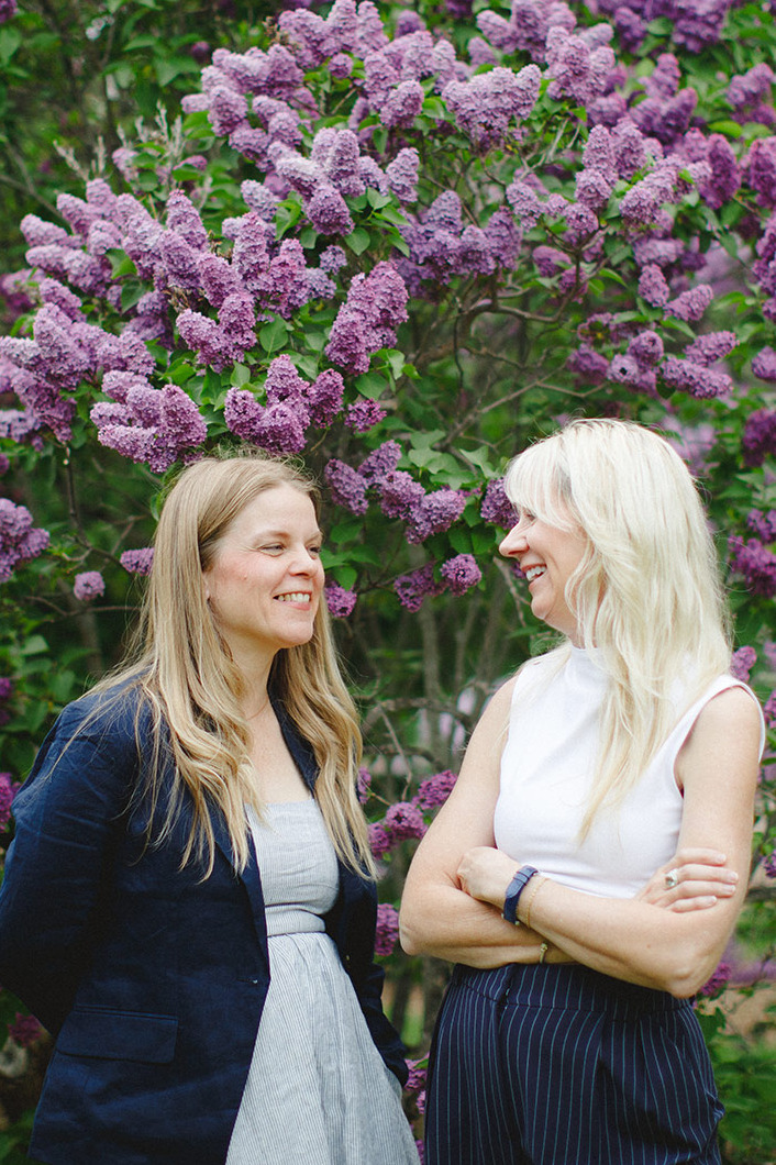 Dr. BreAnna Guan and Dr. Lisa Hanner-Robinson outside near blossoms