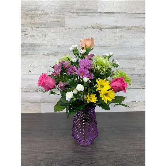 Looking to send someone a little joy? We’ve got the perfect mixed floral arrangement for you! These colorful blooms will put a smile on anyone’s face! No matter what your occasion, we guarantee they will bring a little joy to someone special! We strive to send the freshest flowers so to ensure lasting beauty, some flowers may arrive in bud form and will fully bloom over a few days. The benefit is that they will last longer for the recipient to enjoy! Vase color may vary based on local availability.