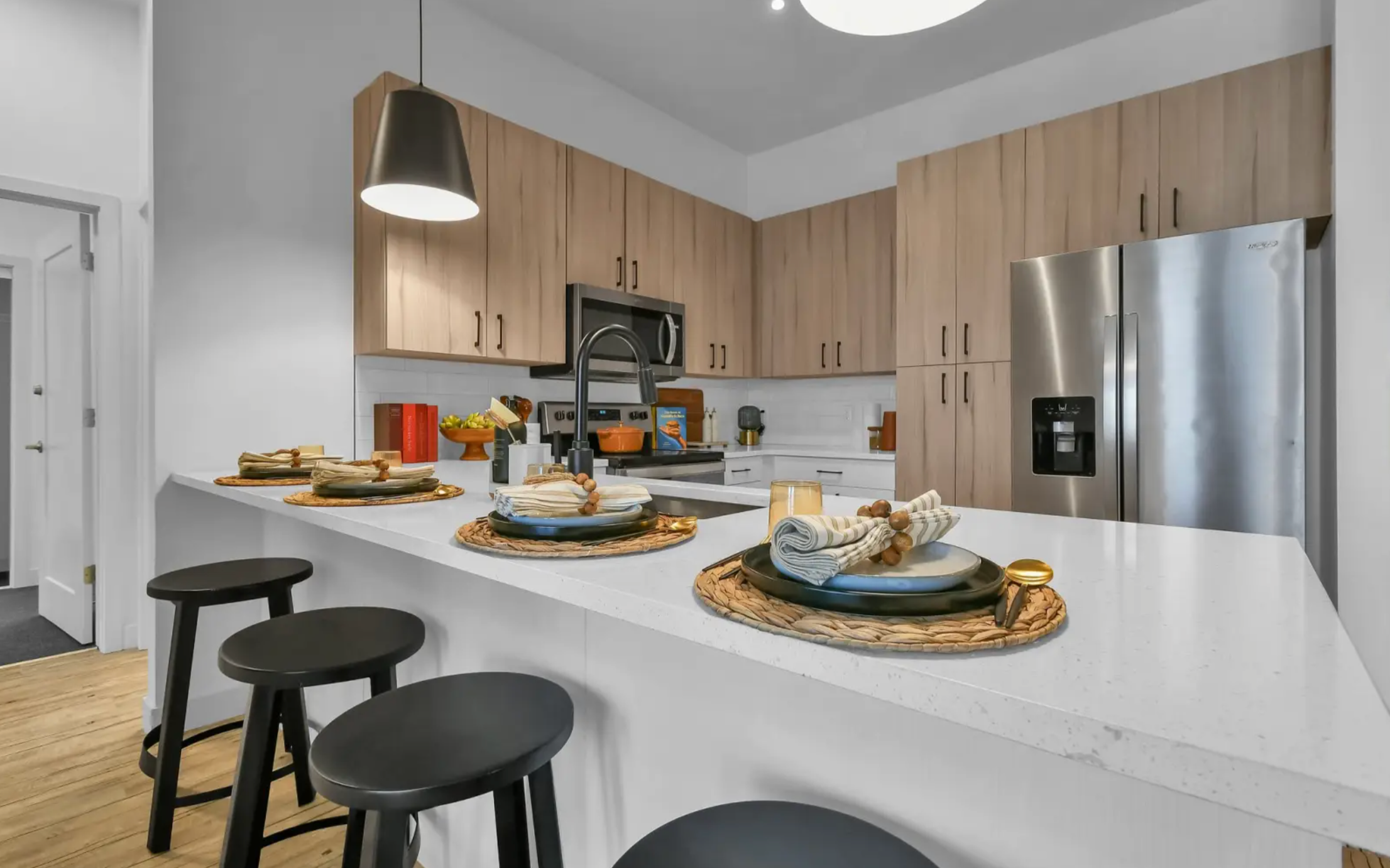 Quartz countertops, stainless steel appliances, breakfast bar, and ample kitchen storage. 