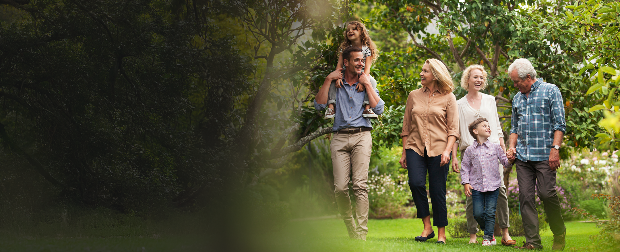 A multigenerational family walking through a garden.