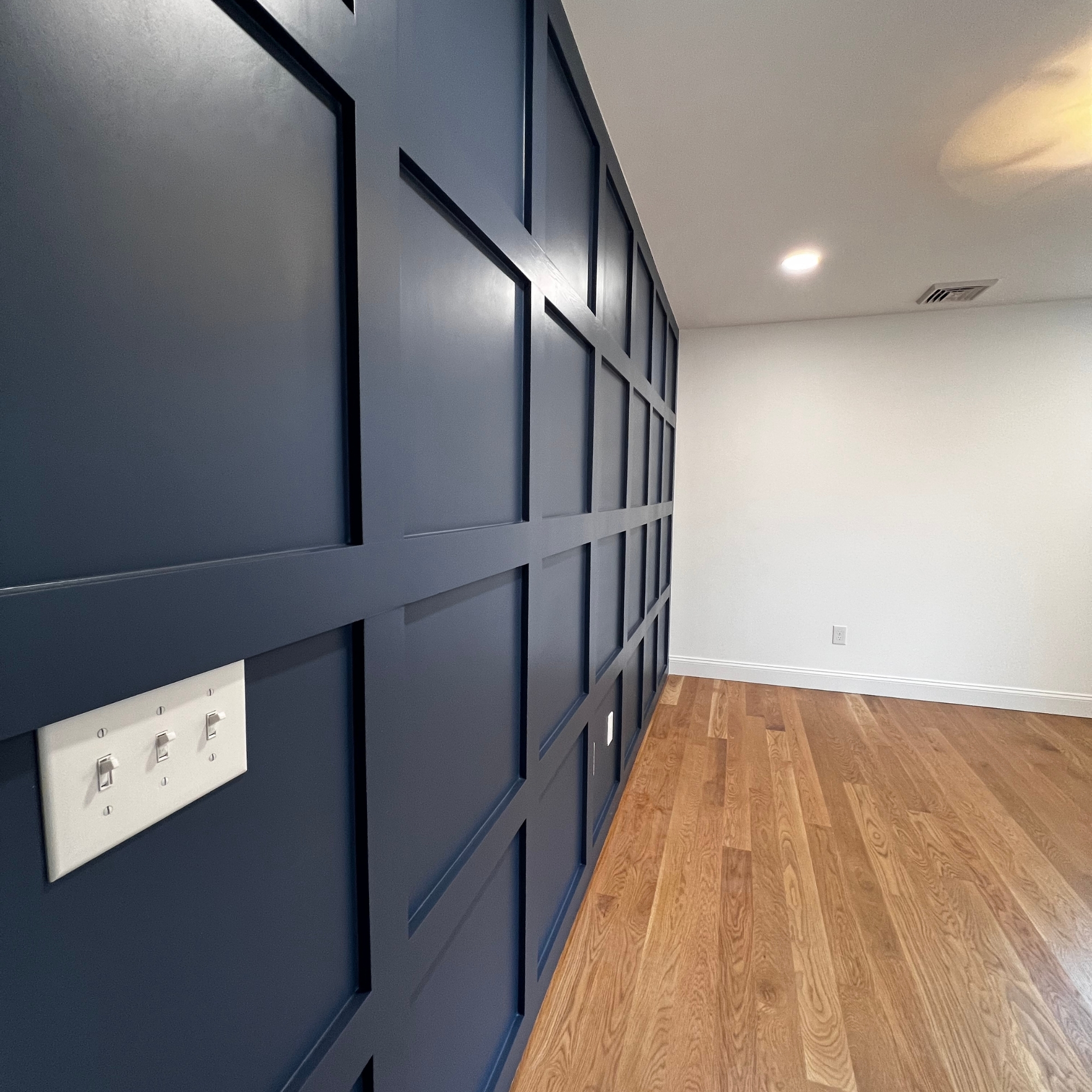 Modern office space with stylish blue wall paneling.