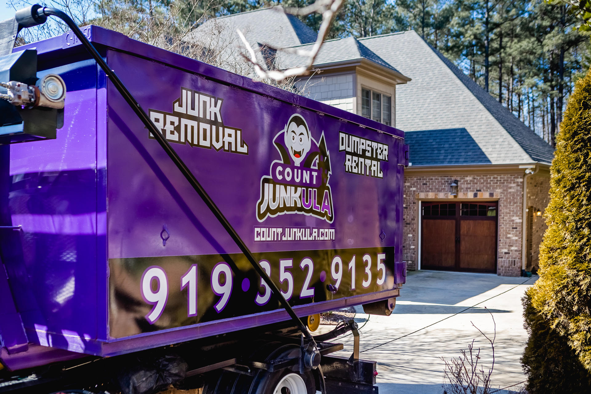 count junkula of raleigh branded dumpster parked