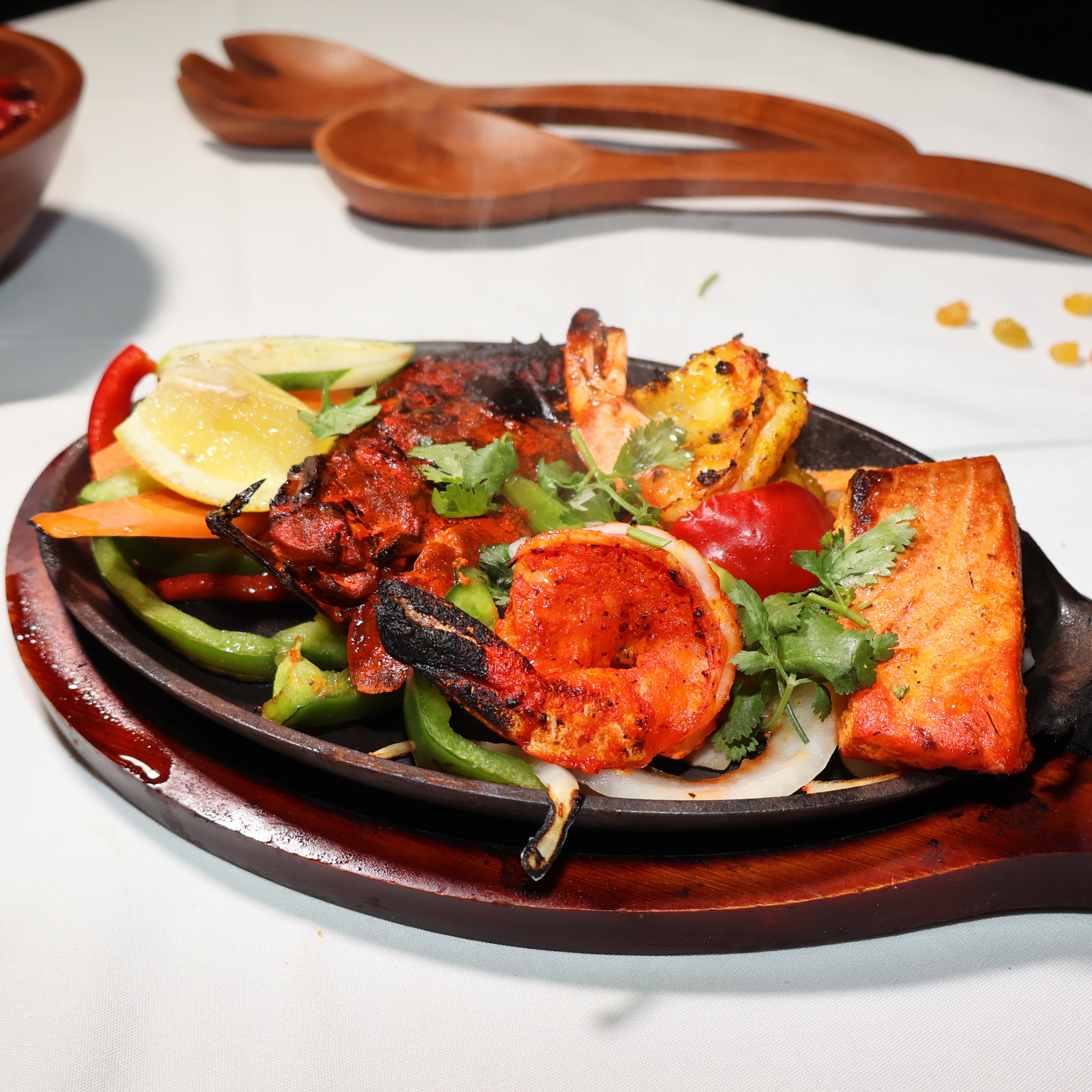 A sizzling medley of fresh seafood—fish, prawns, and calamari—marinated in aromatic Indian spices an 