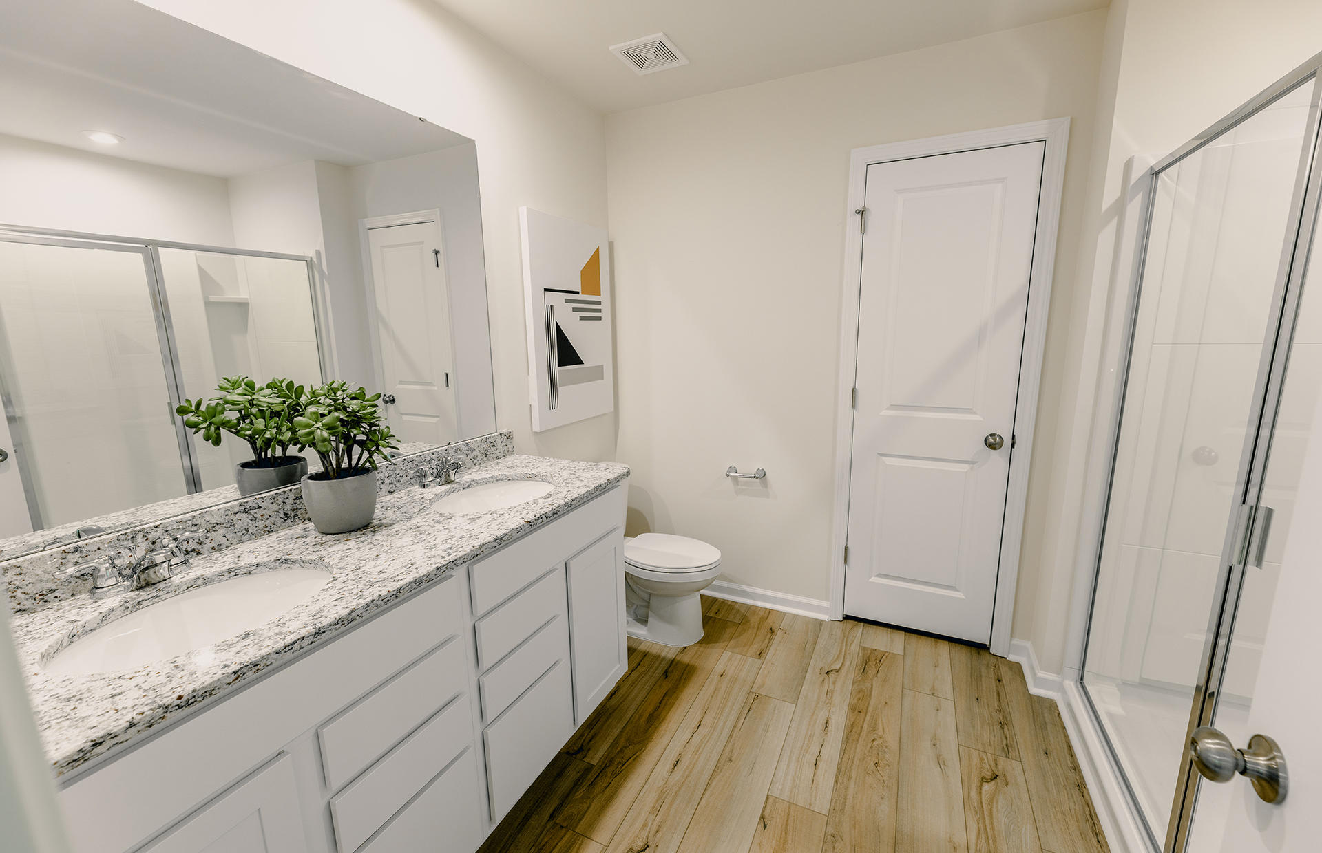 Owner's Baths with Dual Sink Vanities and Walk-in Showers