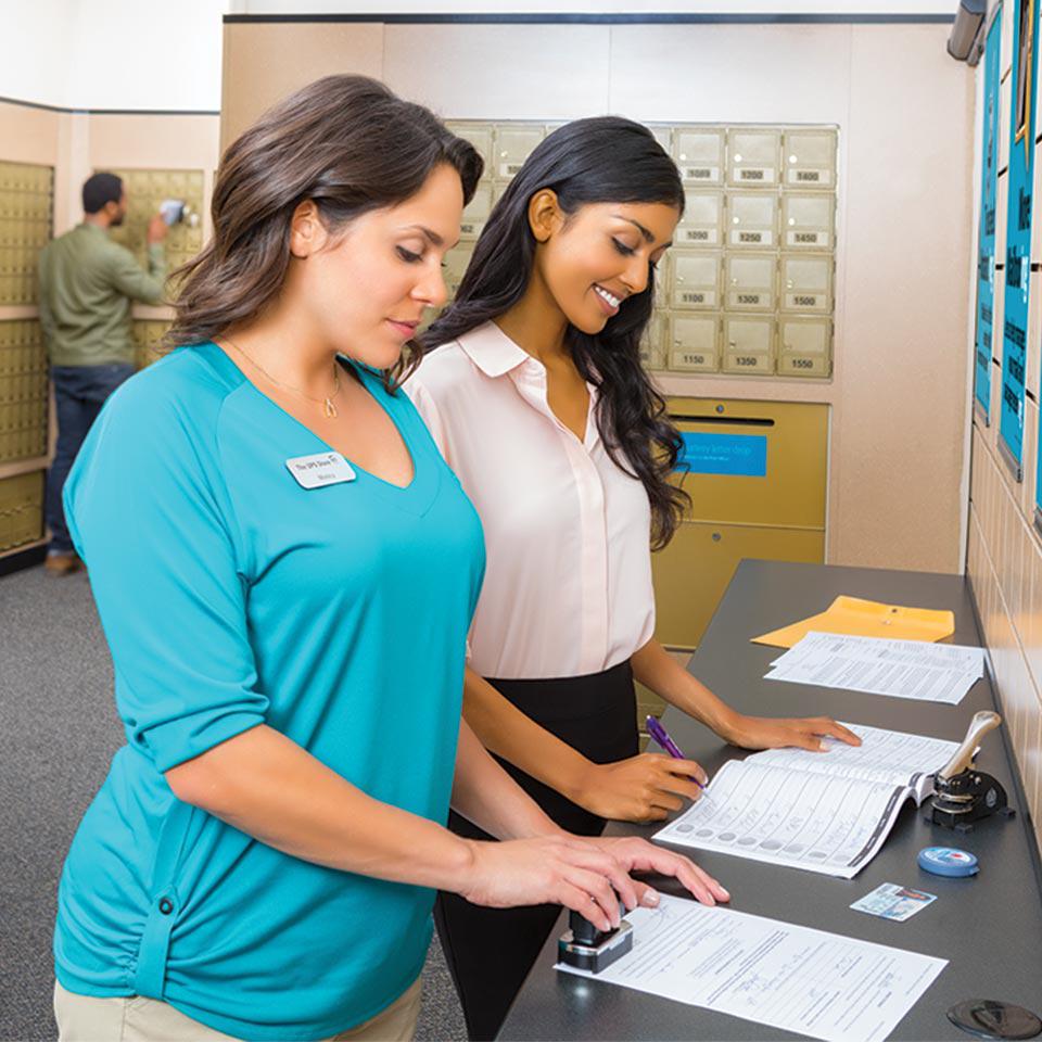 a notary public from The UPS Store notarizes a customer's documents