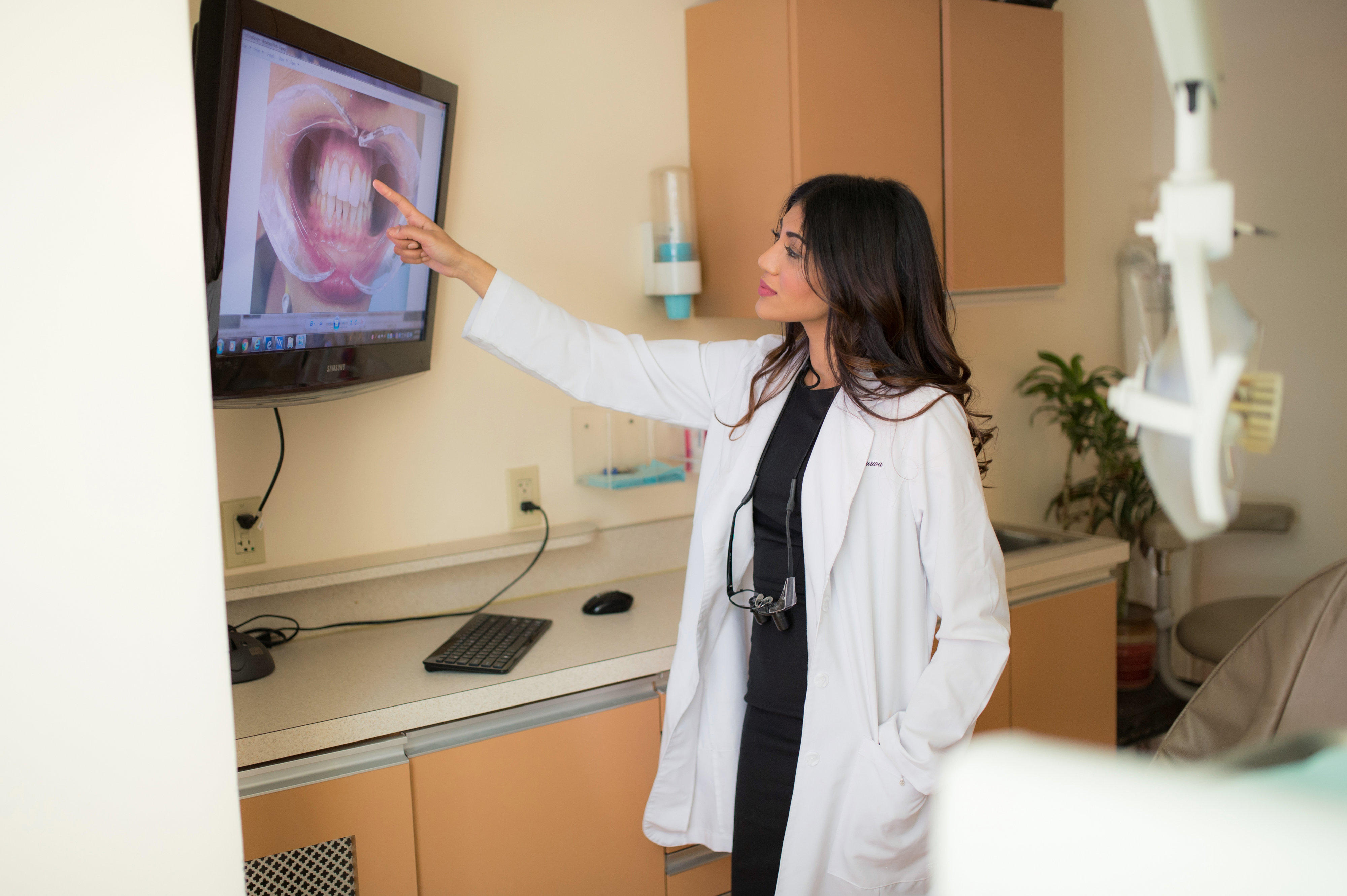 Midtown Dental Care Dr. Randhawa looking at x-ray