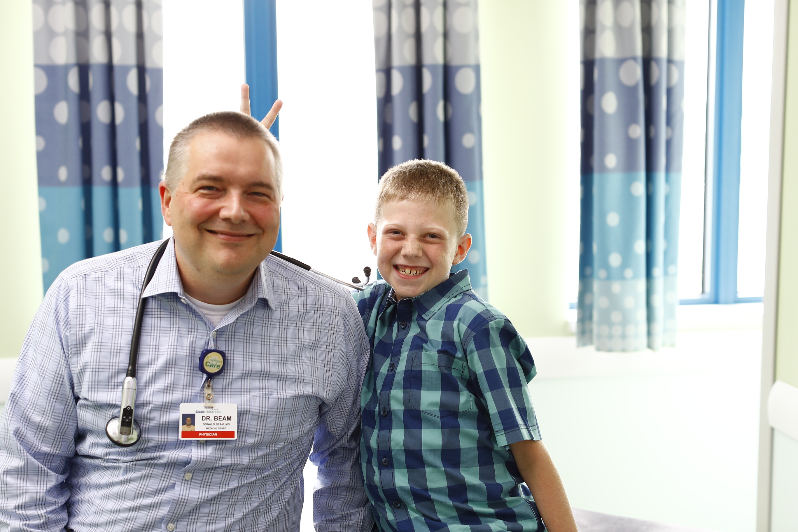 Dr. Beam with a patient in the Cook Children's Hematology and Oncology Clinic