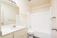 Bathroom with single sink counter, vanity mirror, and shower bathtub combination.