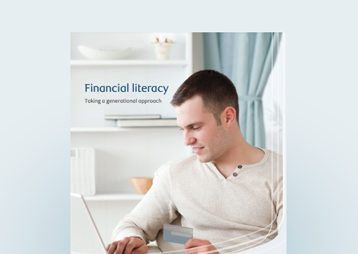 Cover of the financial literacy guide with a young man on his laptop.