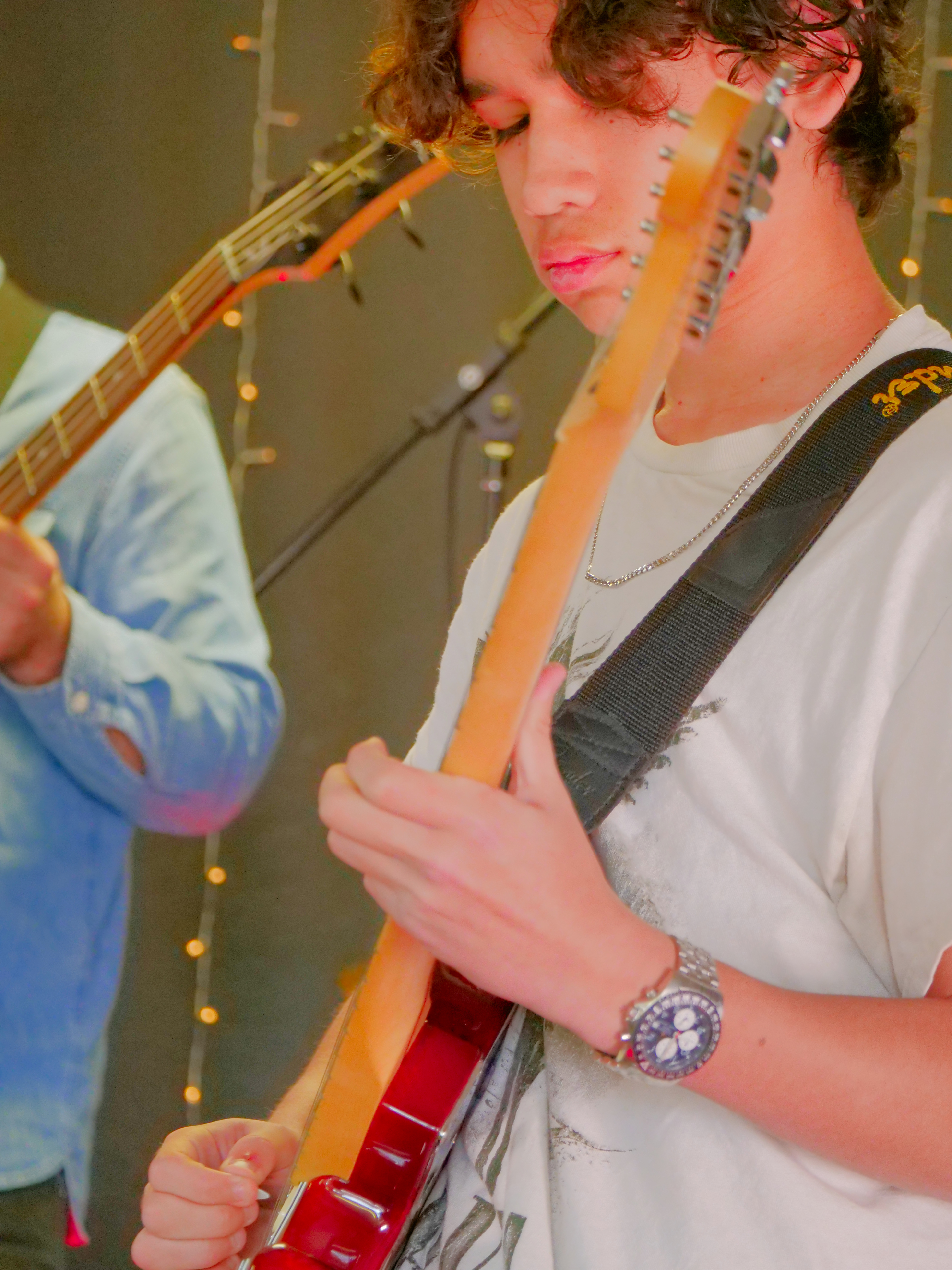 Guitar student performing live, showcasing hands-on music instruction and student band training.