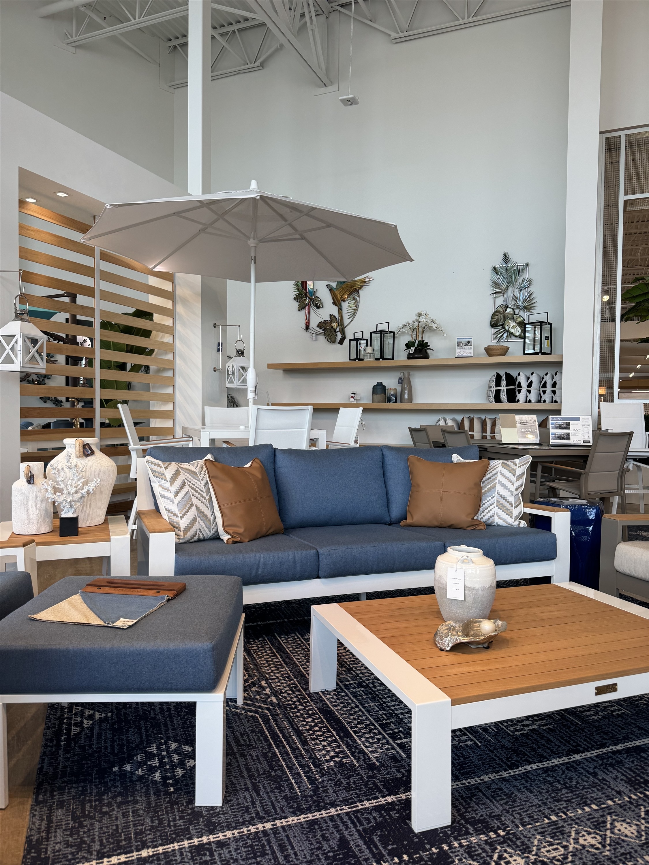Create a coastal-inspired outdoor living space with this navy cushioned sofa and teal lounge chair set