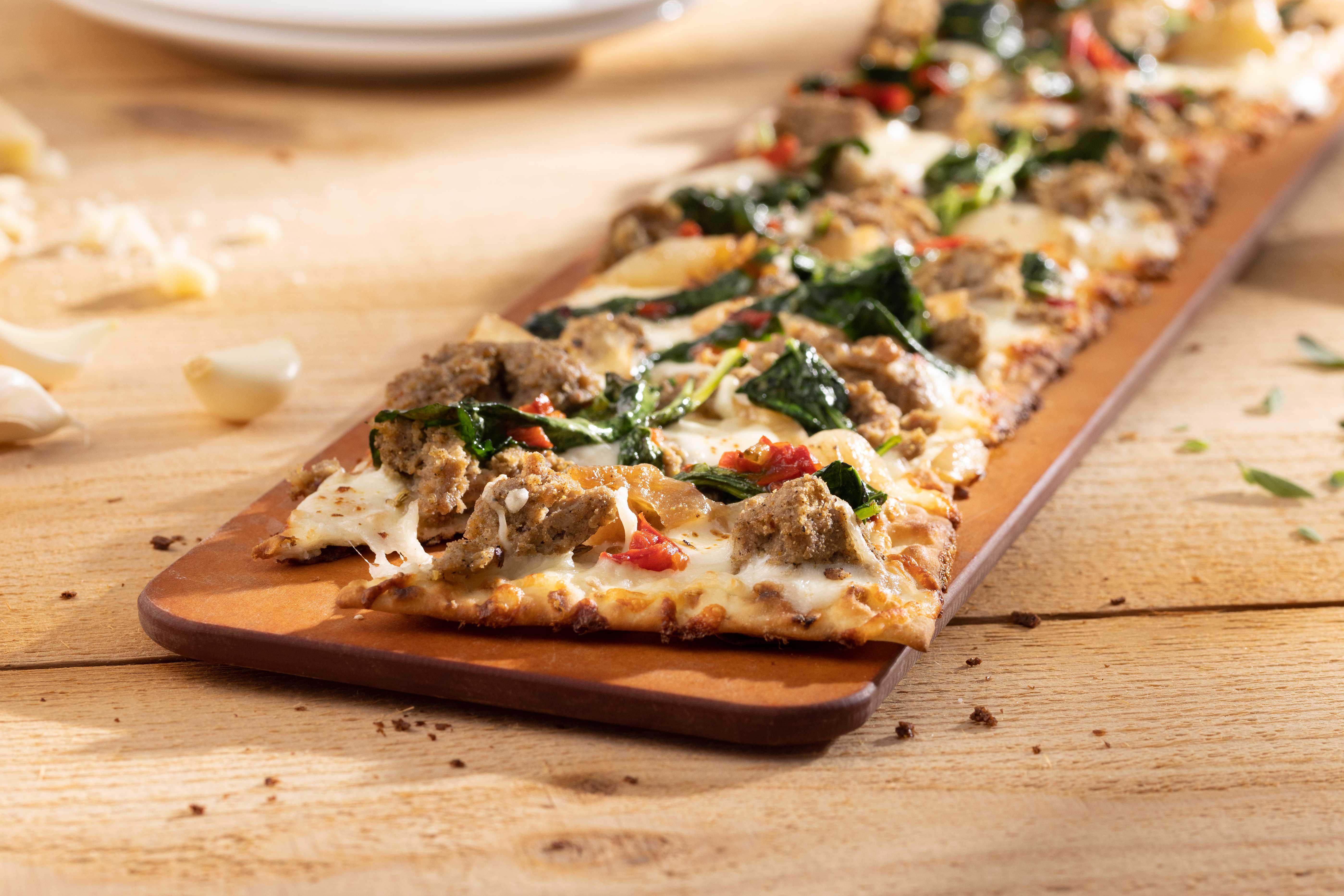 Sausage and Baby Kale Flatbread - housemade Italian sausage, cipollini onions, spicy pepper relish