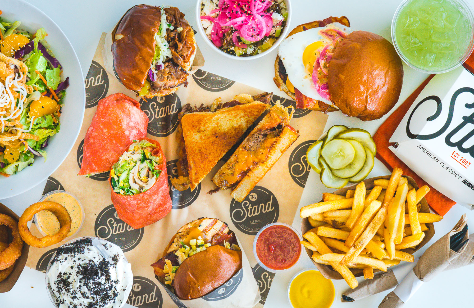 The Stand - American Classics Redefined - Over head photo of multiple food items.