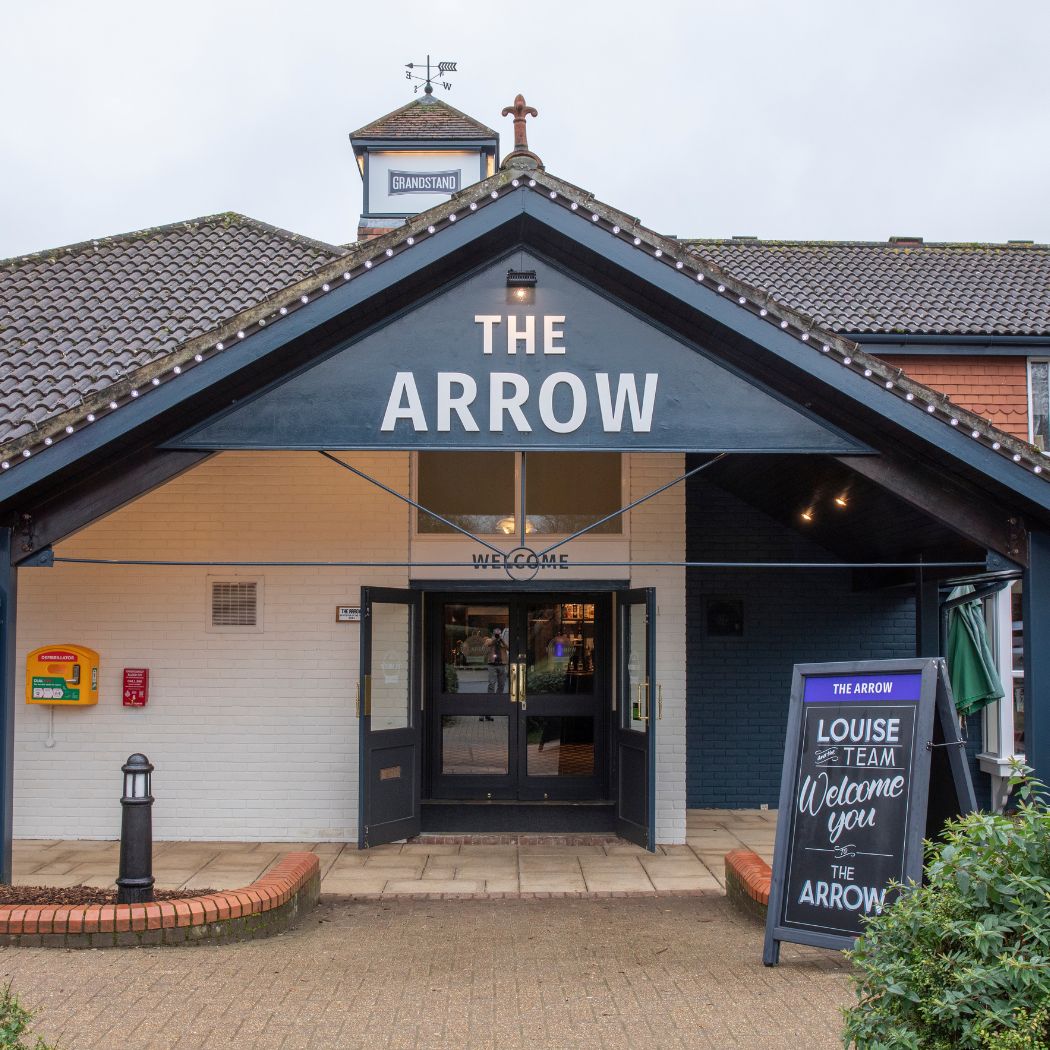 The main entrance of The Arrow pub, featuring clear signage, a covered doorway and welcoming front signage, creating an inviting arrival point for visitors.