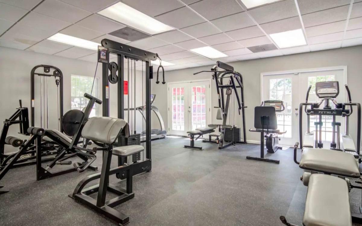 Fitness center with cardio and weight machines.