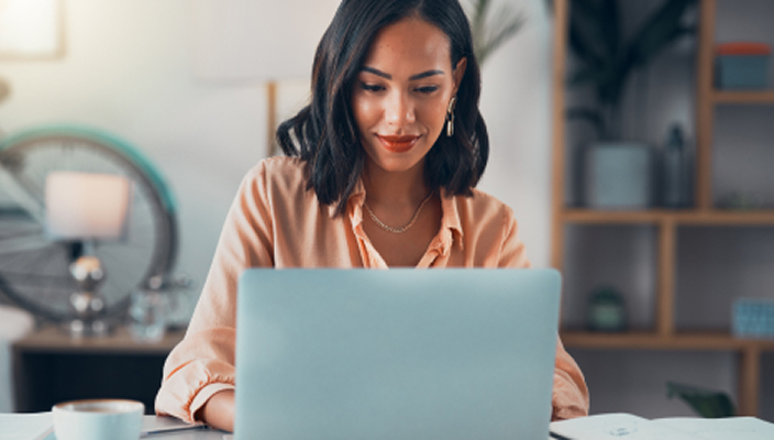 A woman on her laptop in her office.
