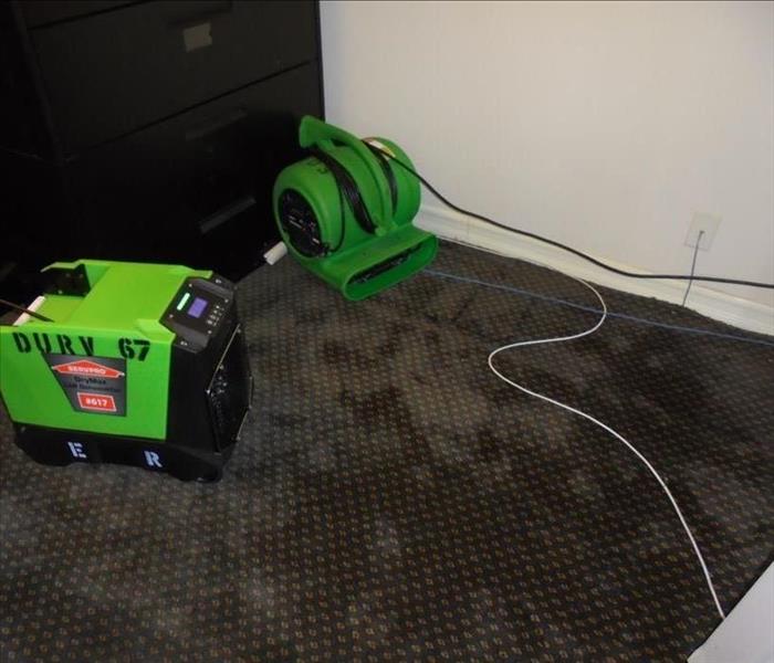 Saturated carpet due to rain water coming in from the balcony door. SERVPRO was called out and on site in within the hour. Our tech was able to lift the carpet without damaging it and dried it in place. The owner was worried she would have to replace the carpet in the room. She was relieved when she was told everything was dried and put back into place.