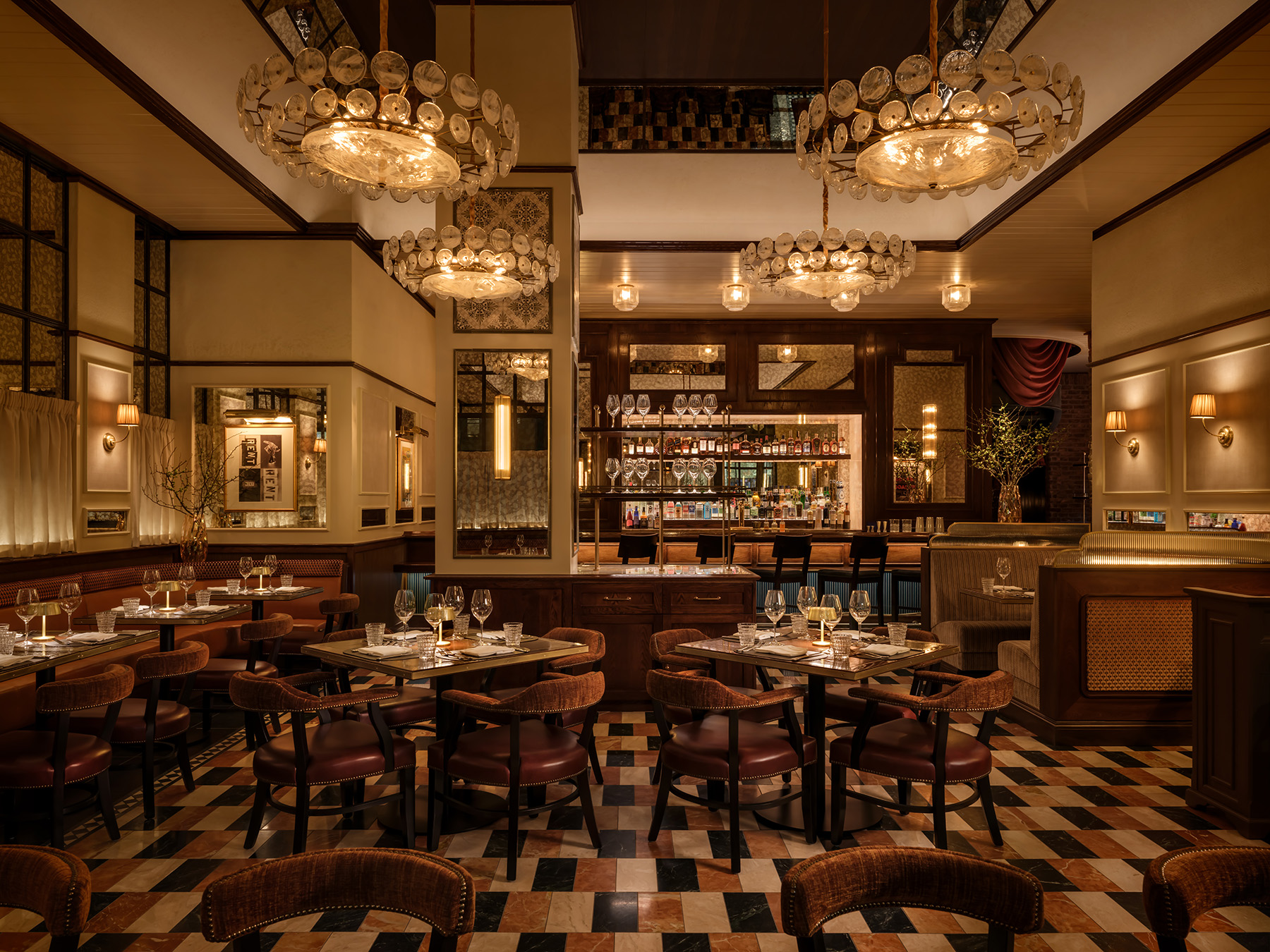 Elegant Art Deco dining room with glass chandeliers and checkered floors at Carversteak NYC.