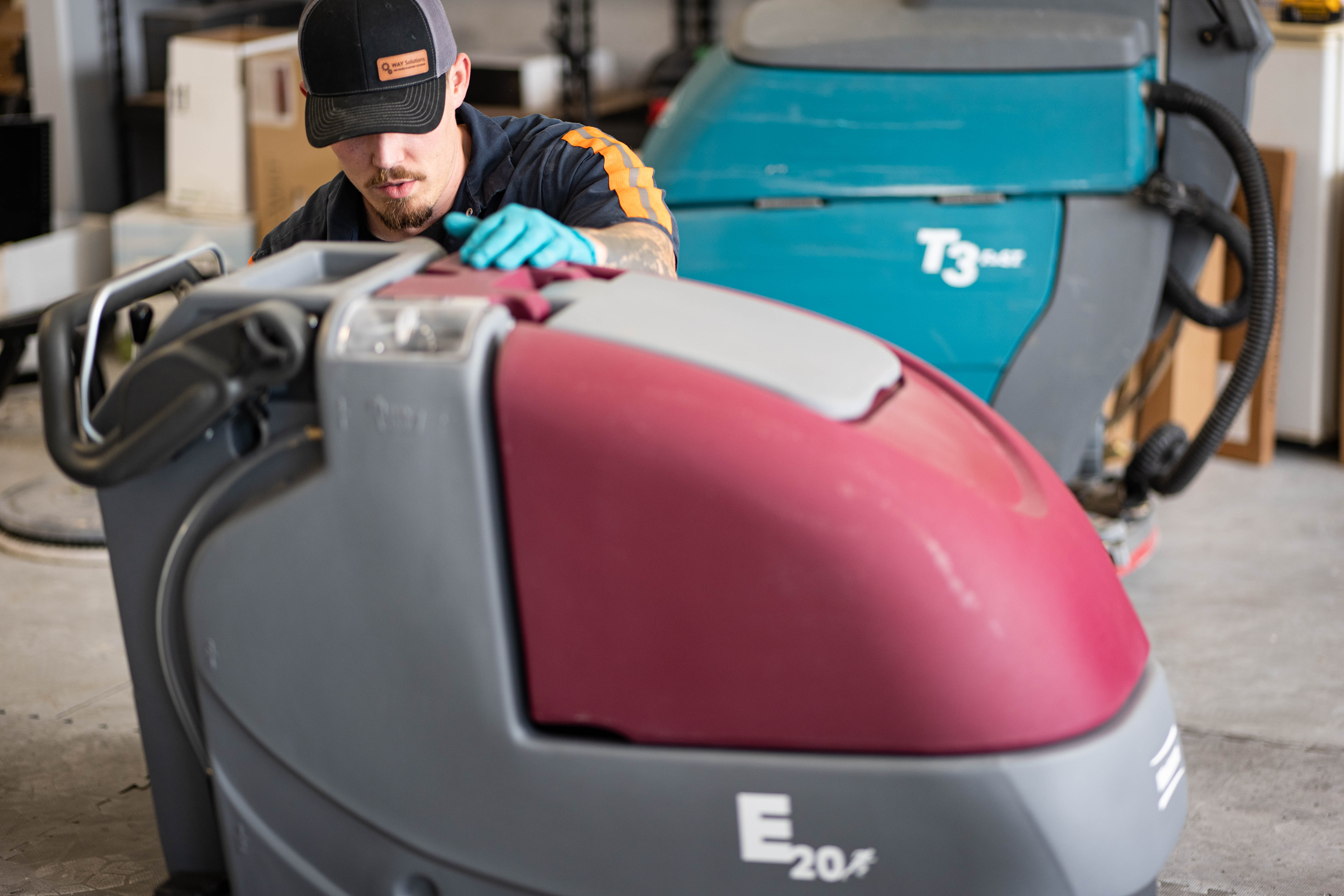 WaySolutions lead technician Kaden performs deep electrical diagnostics on the open control console of an Advance ride-on commercial floor scrubber. Utilizing a digital multimeter, our Layton-based team traces wiring faults to their root cause, ensuring that heavy-duty supermarket and retail cleaning fleets receive lasting, reliable repairs rather than superficial fixes.